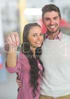 Couple Holding Keys with car