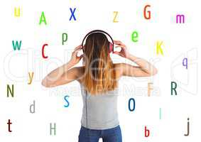 young woman listening music with colour letters around. White back.