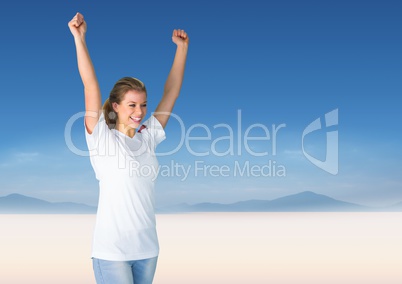 Woman cheering against blurry desert