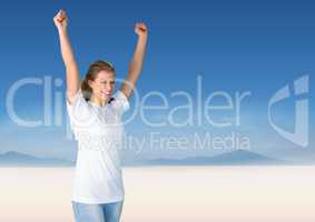 Woman cheering against blurry desert