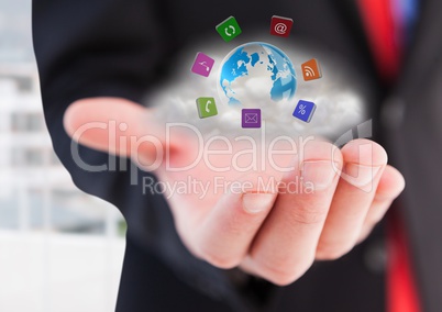 Businessman hand with application icons around earth with cloud behind.