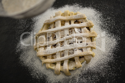 Cropped image of strainer over pie