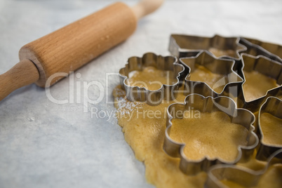 Close up of various pastry cutters over dough
