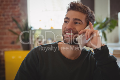 Man talking on phone at cafe