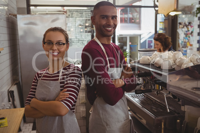 Portrait of smiling confident owners in cafe