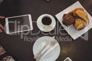 High angle view of muffins with coffee on table