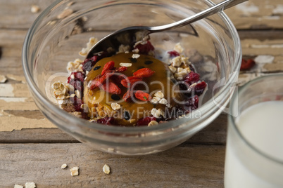 Breakfast cereals and milk on wooden table