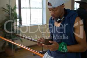 Male dancer using digital tablet in studio