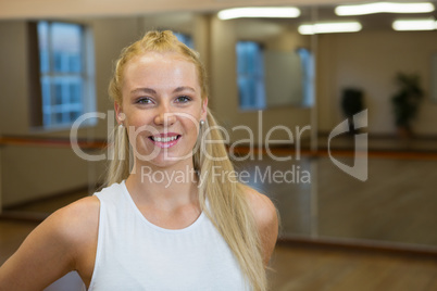 Portrait of happy female dancer in studio