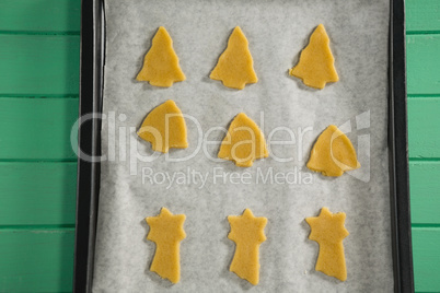 Close up of various shape raw cookies in baking tray