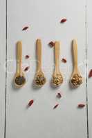 Various oatmeal in wooden spoon