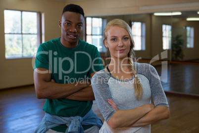 Portrait of confident young dancers in studio