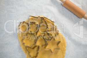 Overhead view of various shape pastry cutter on rolled dough