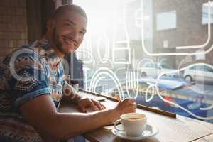 Portrait of man with coffee at window sill in cafe