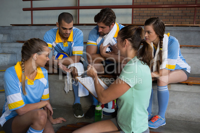 Coach talking with volleyball players