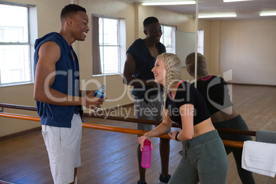 Smiling dancers talking in studio