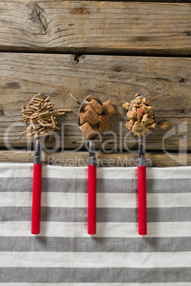 Three spoons with various breakfast cereals