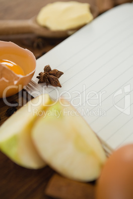 Close up of apple slices with book and egg