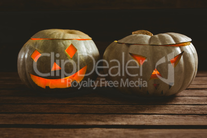 Close up of illuminated jack o lanterns on table during Halloween