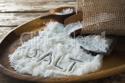 Word salt on wooden plate