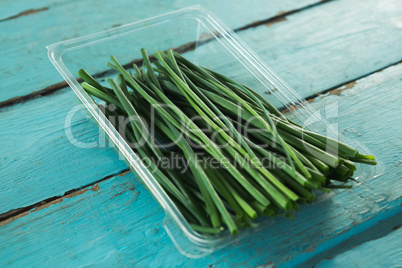 Garlic chives in plastic container