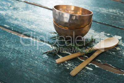 Golden steel bowl, spatula and spoon on table