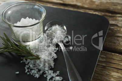 Salt in glass bowl and rosemary herb
