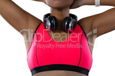 Mid section of female athlete with headphones