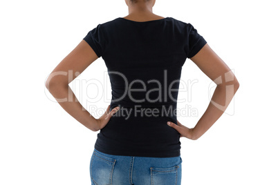 Mid section of young woman with hands on hip