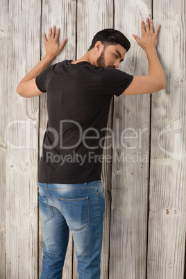 Man posing against wooden background