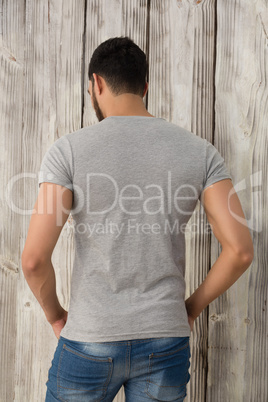 Rear view of man standing with hands in pocket