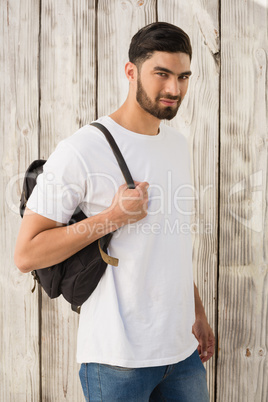 Handsome man posing against wooden background