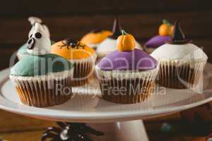 Close up of colorful cup cakes arranged on stand