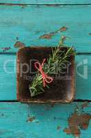 Tied rosemary in wooden bowl