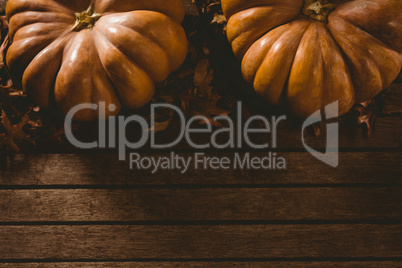 Pumpkins with leaves on table during autumn