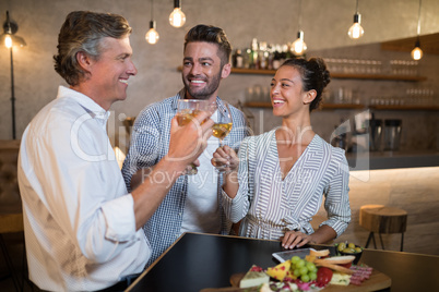 Happy friends toasting drinks