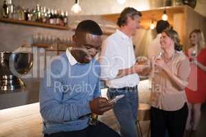 Man using mobile phone while having beer