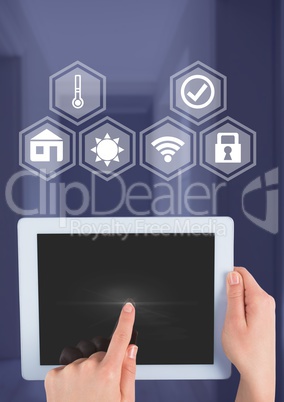 Hand holding tablet with smart home interface at home