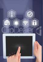 Hand holding tablet with smart home interface at home