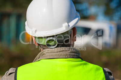 Construction Worker In Hard Hat On Building Site