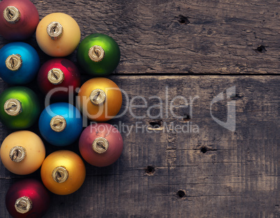 Colorful Christmas baubles on wood