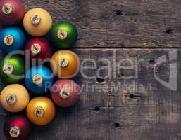 Colorful Christmas baubles on wood