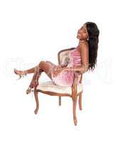 Beautiful woman sitting on an armchair