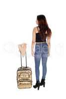 Woman in jeans with a suitcase