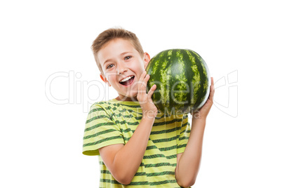 Handsome smiling child boy holding green watermelon fruit