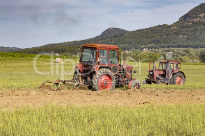 Old tractor working on the field