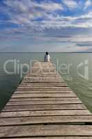 Young girl out on the wooden pier