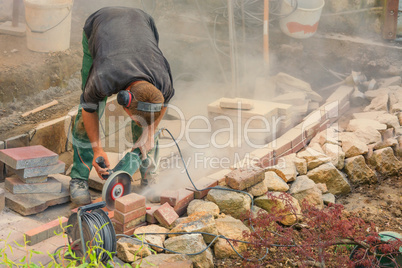 Craftsman works with an electric grinding machine