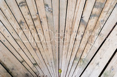 Worn wood planks converging in perspective.