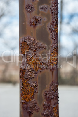 Rusted post with paint blistering off.